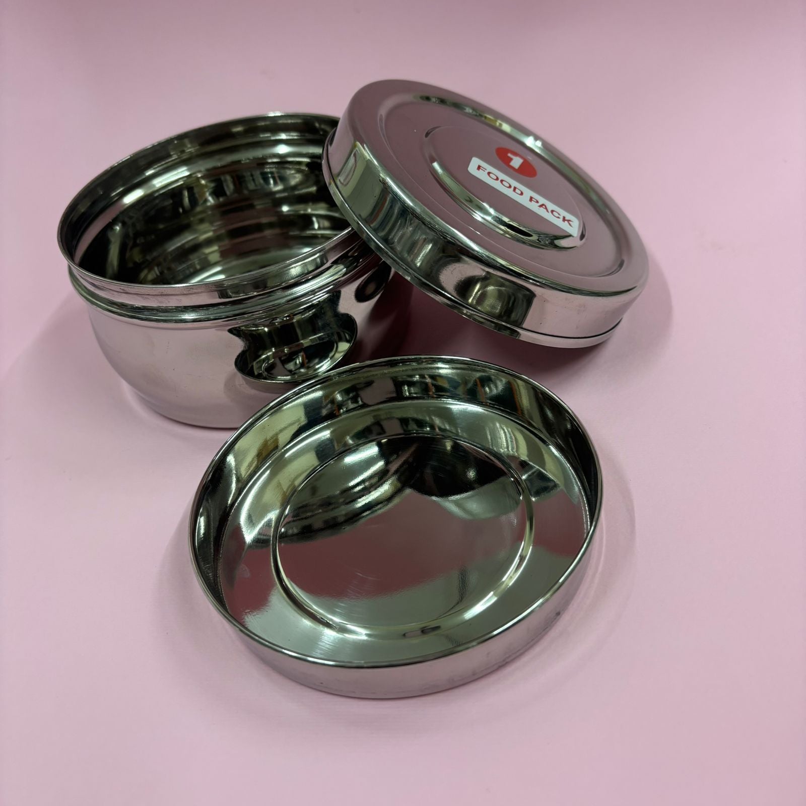 Spacious bulging stainless steel lunchbox with secure lid for carrying meals