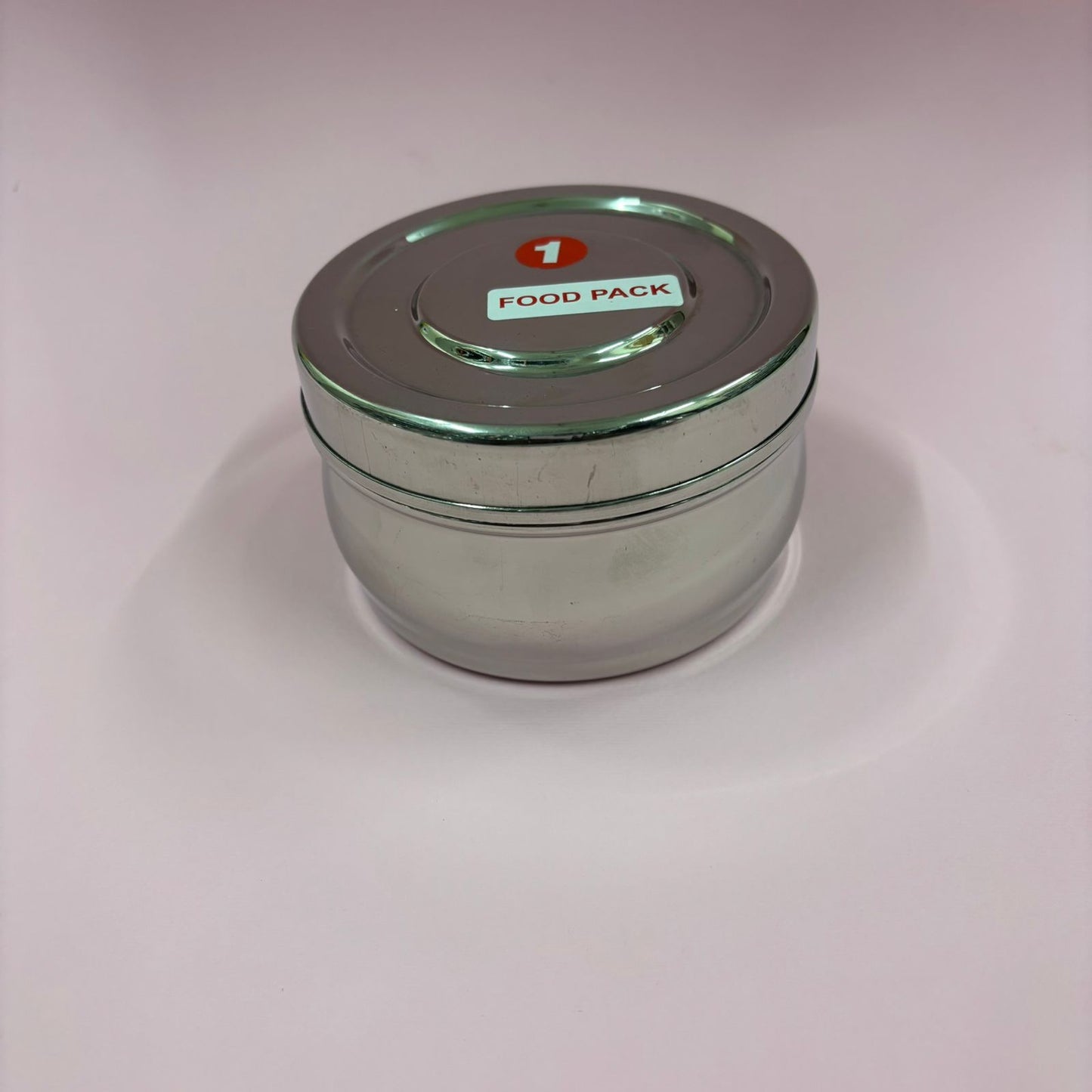 Spacious bulging stainless steel lunchbox with secure lid for carrying meals