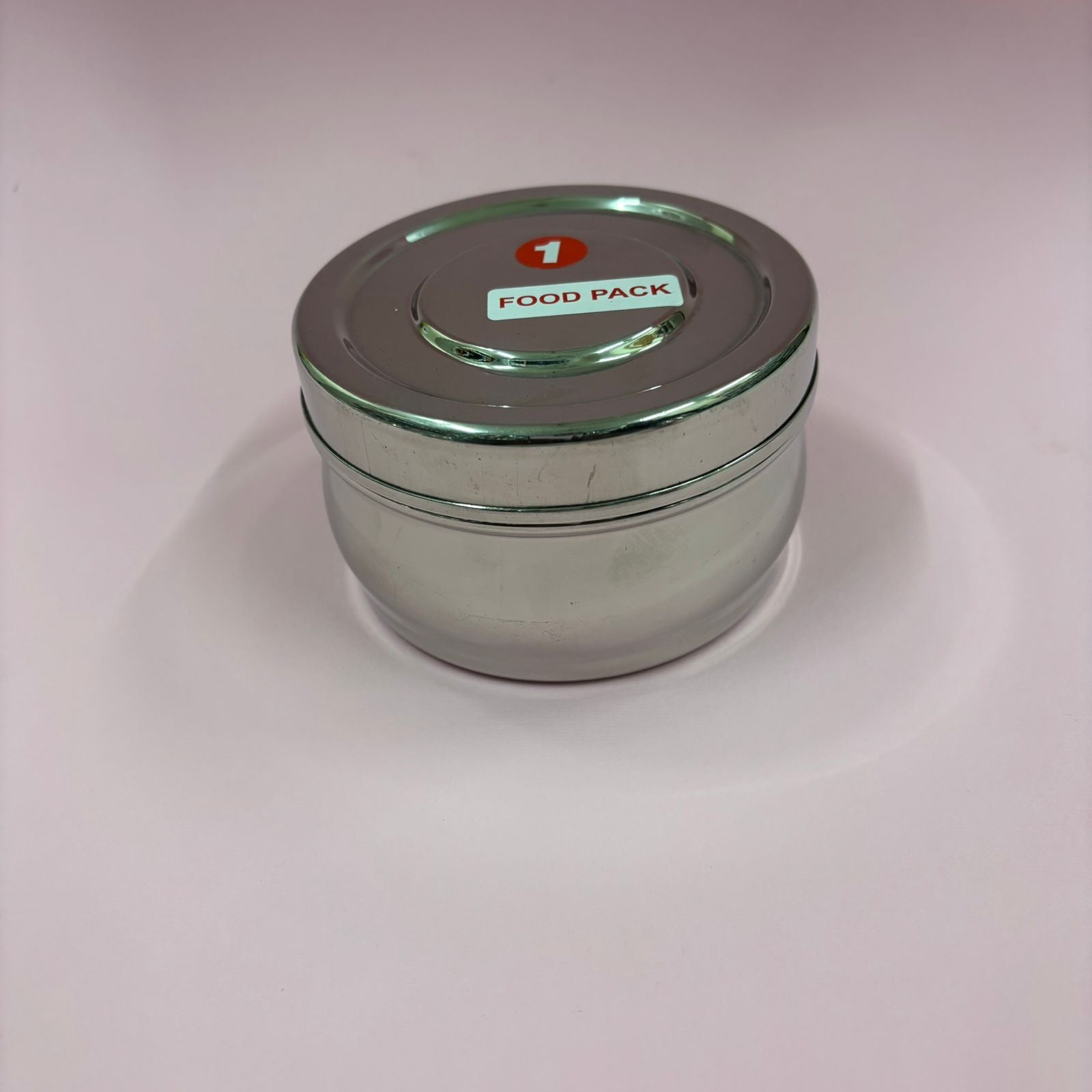 Spacious bulging stainless steel lunchbox with secure lid for carrying meals