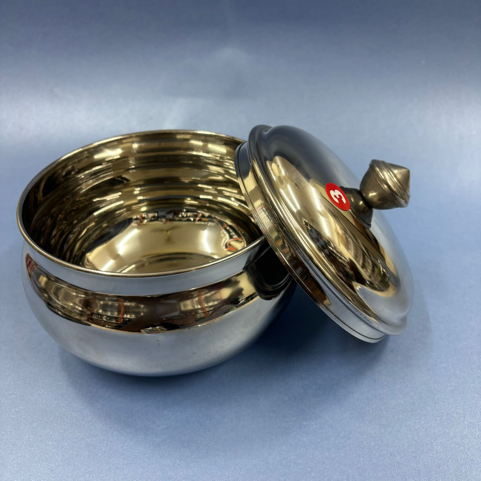 Elegant mango-shaped stainless steel curd pot for storing and serving curd