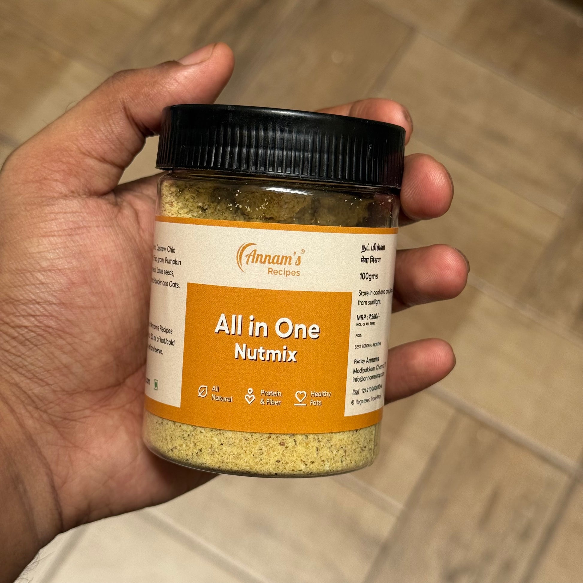 Nut mix powder with almonds, saffron, and seeds displayed in a bowl with ingredients spread around for a healthy lifestyle concept.