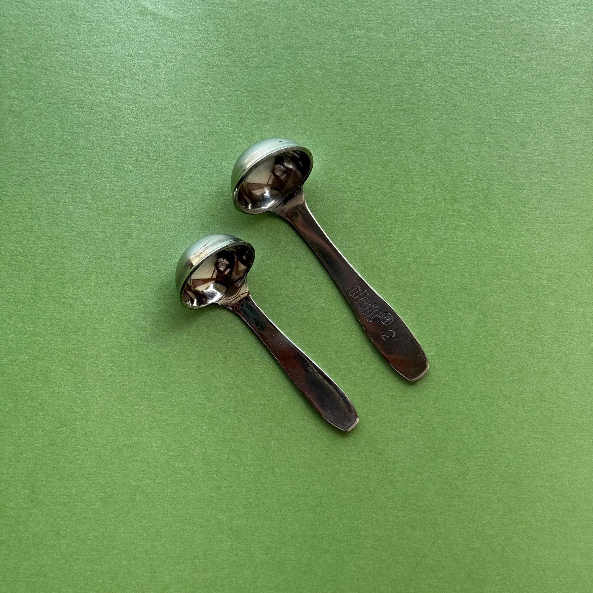Pair of stainless steel ghee spoons – top view with polished handles
